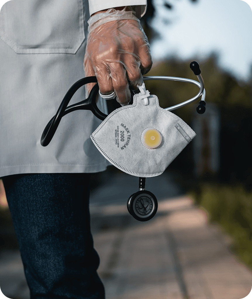 Doctor holding a stethoscope and a face mask