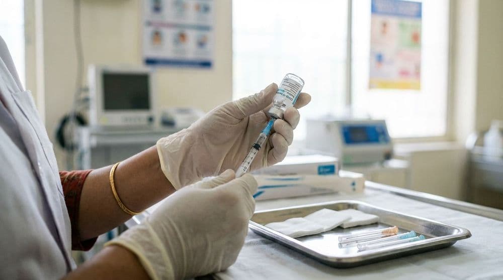 A healthcare professional preparing a measles vaccine in a clinic in North India. A healthcare professional preparing a measles vaccine in a clinic in North India.